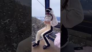 A woman's struggle to zip her ski pants.